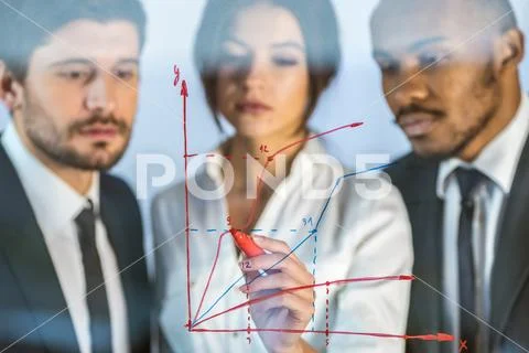 The serious people draw the graph at the virtual screen Stock Photos