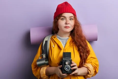 Serious pleasant female backpacker using her camera Stock Photos