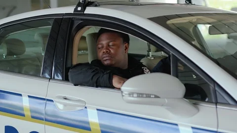 Serious portrait two men cops sitting in patrol car accepting emergence call Stock Footage 112954678