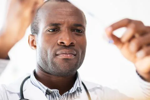 Serious practitioner taking sample for examination Stock Photos