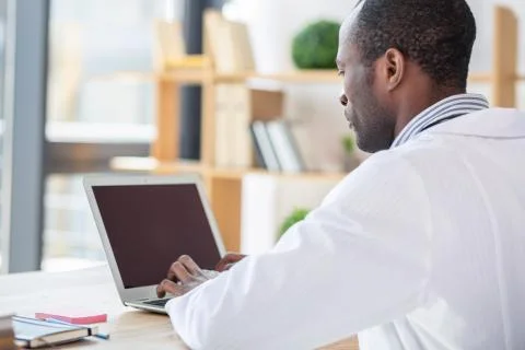 Serious practitioner using his laptop Stock Photos