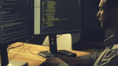 Serious professional hacker being involved in coding Stock Footage 75020426