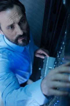 Serious professional programmer working in the data center Stock Photos