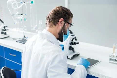 Serious professional scientist using a tablet Stock Photos