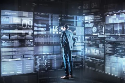 Serious programmer looking thoughtful while standing in front of the screen Stock Photos