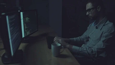 Serious programmer working at night Stock Footage 75018983