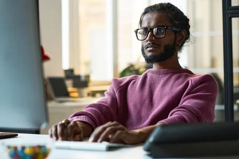 Serious programmer working online on computer 写真素材