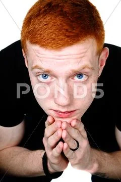 Serious redhead boy with deep blue eyes Stock Photos