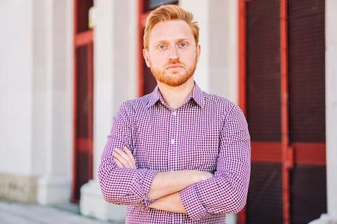 Serious Redhead Man Looking at Camera standing outdoors. Close Up Portrait of Stock-Fotos