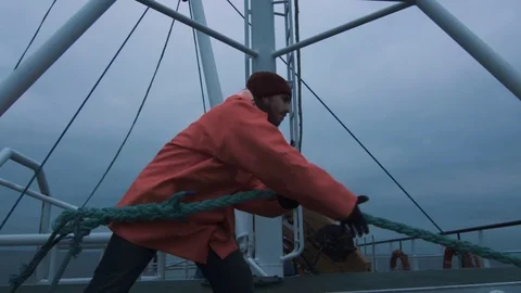 Serious Seaman Pulls the Thick Rope during Traveling on the Ship Stock Footage 70154024