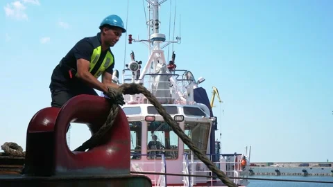 Serious Seaman worker Pulls a Thick Rope during Traveling on the Ship.  Stock Footage 133627363