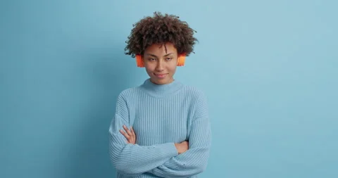 Serious self confident dark skinned charismatic woman keeps hands crossed wears Stock Footage 144916931