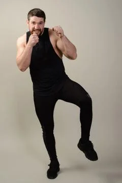 Serious severe bearded fighter standing in a fighting defensive stand with .. Stock Photos