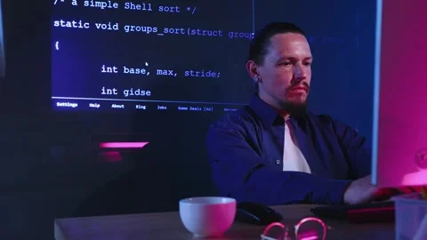 Serious, smart, concentrated man, web developer, programmer using computer for Stock Footage 245343080
