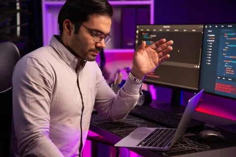 Serious smart IT developer meeting via application team record laptop. Surmise. 스톡 사진