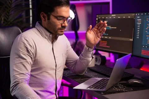 Serious smart IT developer meeting via application team record laptop. Surmise. Stock Photos