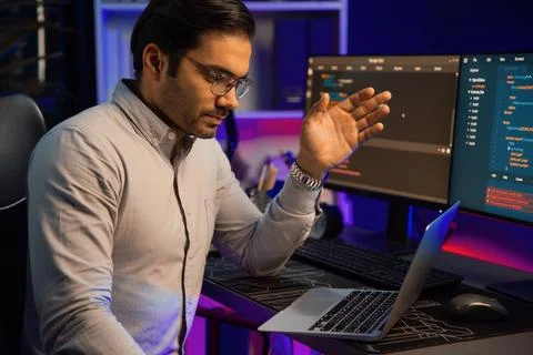 Serious smart IT developer meeting via application team record laptop. Surmise. 스톡 사진