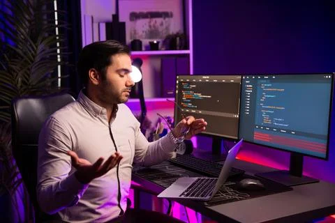 Serious smart IT developer meeting via application team record laptop. Surmise. Stock Photos
