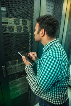 Serious smart male engineer testing the system Foto stock
