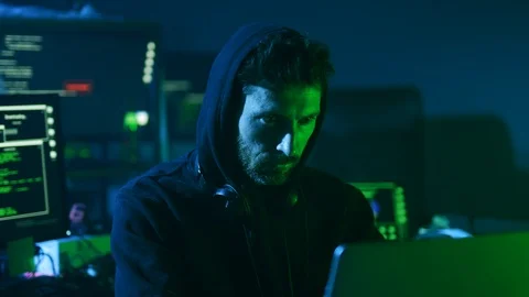 Serious smart programmer writing data code developing a program on multiple Stock Footage 108822990