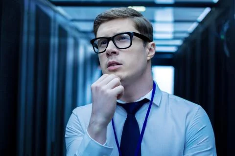 Serious smart young operator thinking Stock Photos