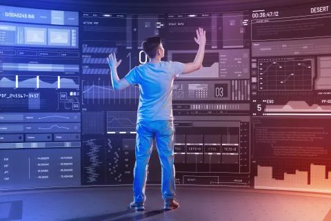 Serious software developer putting his hands up while working in a modern office Stockfoto's