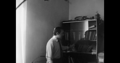 Serious Soviet Man Standing Next to a Bookcase in His Office Video stock 322191809