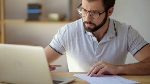 Serious student in glasses studying online from home Stock Footage 78735979