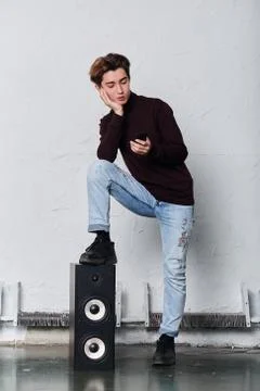 Serious stylish man using his smart phone while standing in the music studio Stock Photos