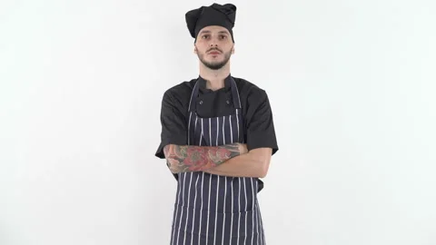 Serious tattooed chef in uniform with his arms crossed looking at camera Stock Footage 144530848