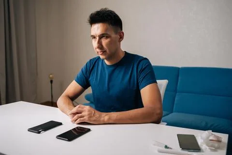 Serious technician male preparing to insert smartphone into protective case Stock Photos