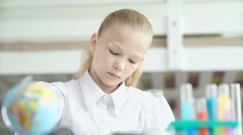 Serious teen girl doing homework. 11-13 years old girl Stock Footage