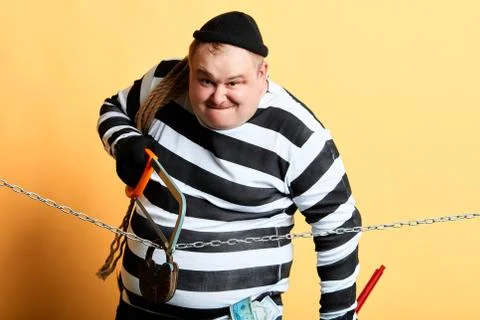 Serious thief using saw to cut the chain Stock Photos