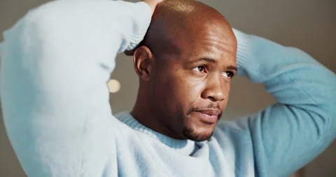 Serious, thinking and black man with stress in home for emotional burden, Stock Footage 336792531