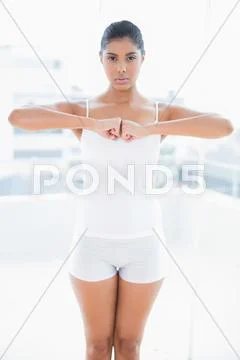 Serious toned brunette meditating Stock Photos