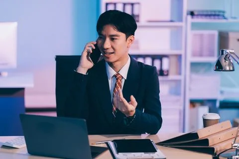 Serious trader using mobile phone app on smartphone for checking stock trad.. Stock Photos