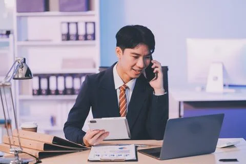 Serious trader using mobile phone app on smartphone for checking stock trad.. 写真素材