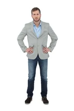 Serious trendy man posing with hands on hips Stock Photos