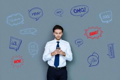 Serious web developer typing messages and looking busy Foto stock