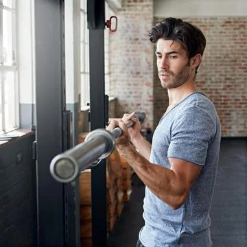 Serious, weight training or man in gym for fitness, curl bar or bicep routi.. Stock Photos