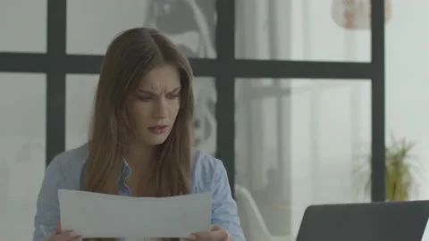 Serious woman face looking documents on laptop home workplace Video stock 150211754