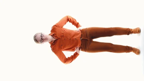 Serious woman with glasses on a white background in the studio dancing dance Stock Footage 128200461