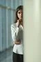 The serious woman stand near the column Photo