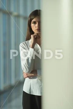 The serious woman stand near the column Stock Photos