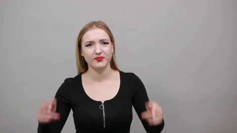 Serious woman thinks solving a problem, holds her index fingers near head Stock Footage 124904076