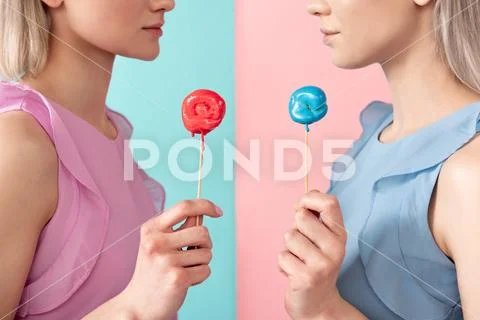 Serious women standing with lollipops Stock Photos