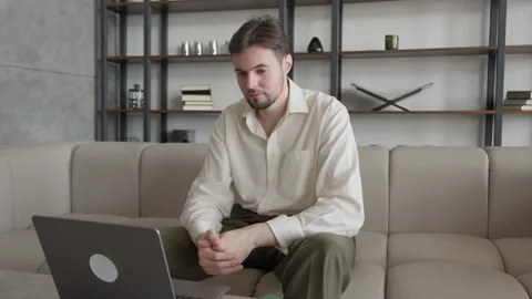 Serious Worker Sitting on Sofa with Laptop in Modern Office 스톡 동영상 301243862
