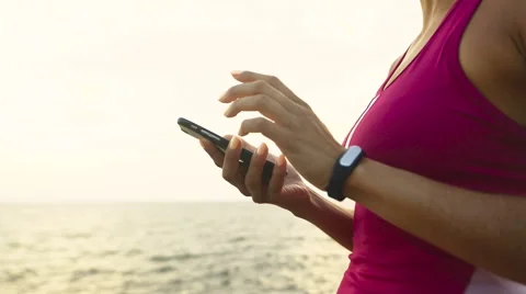 Serious young active woman checking miles on her running watch Stock Footage 68855128