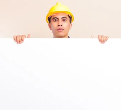 Serious young Asian construction worker wearing yellow hard hat and safety .. Stock Photos