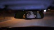 Serious Young Businessman S Face In A Rear View Mirror Driving A Car At Night Stock Footage